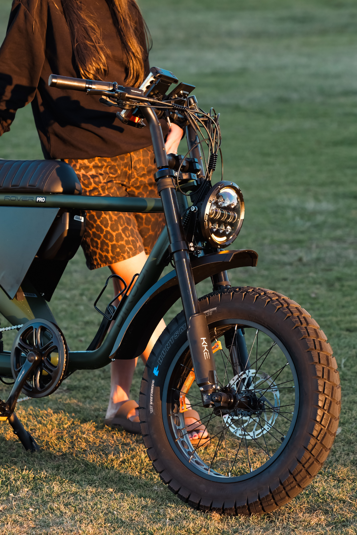 A person stands next to a Dirodi Rover Pro Fat-tyre electric bike.